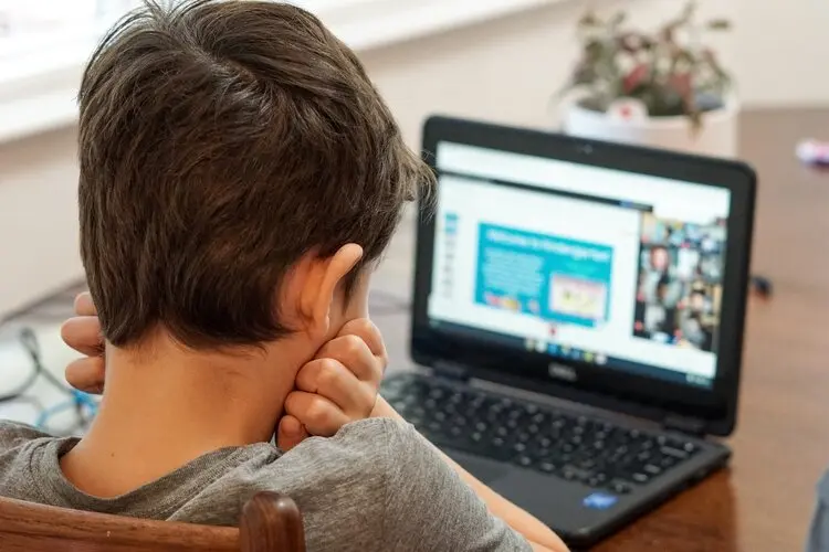 adolescent looking overwhelmed by a laptop computer