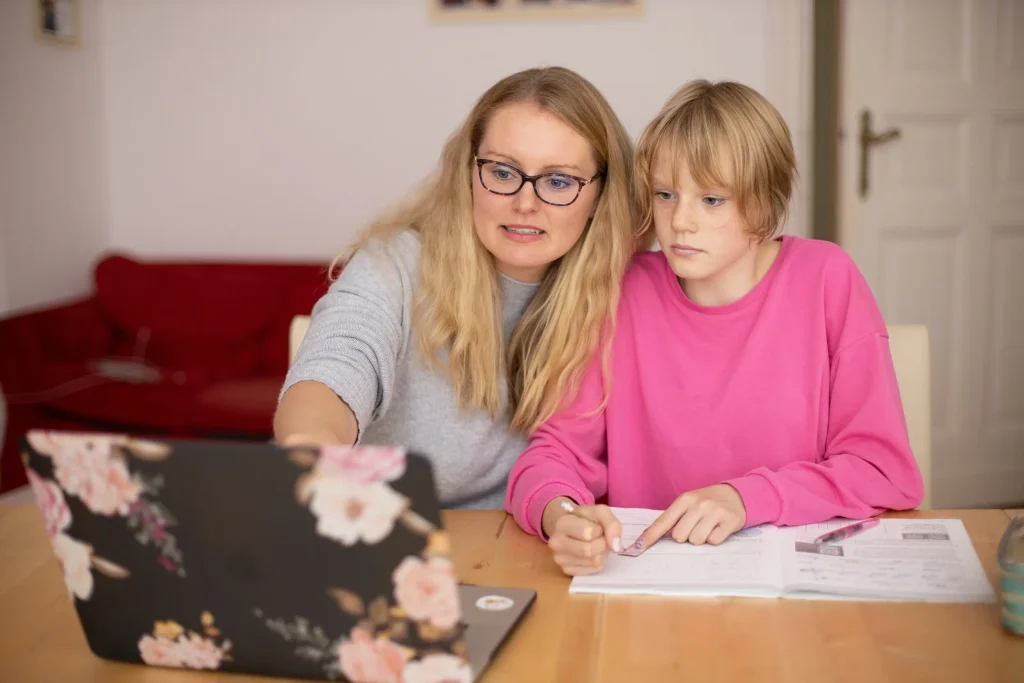 Mother helping daughter with her homework