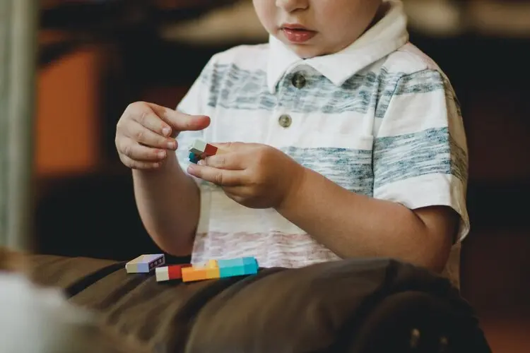 Child playing with lego bricks