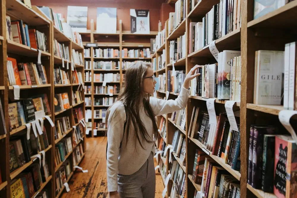 young woman browsing a book store