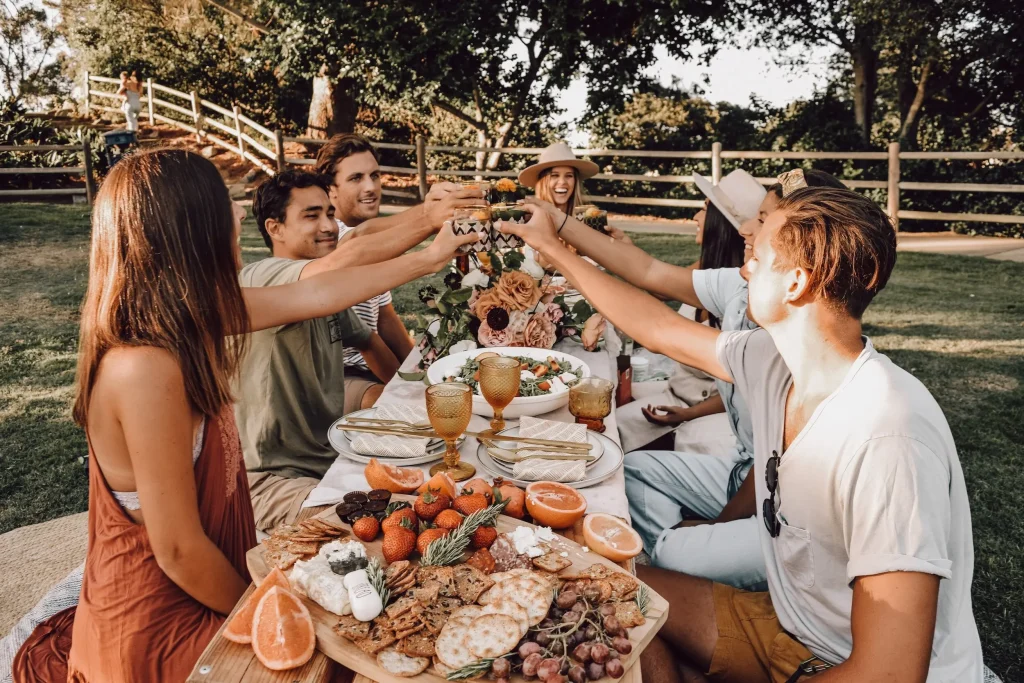 group of friends celebrating at an outdoor meal