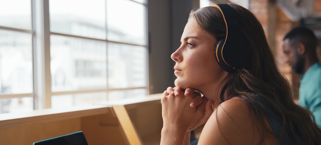 Young woman sitting at her desk considering autism testing.