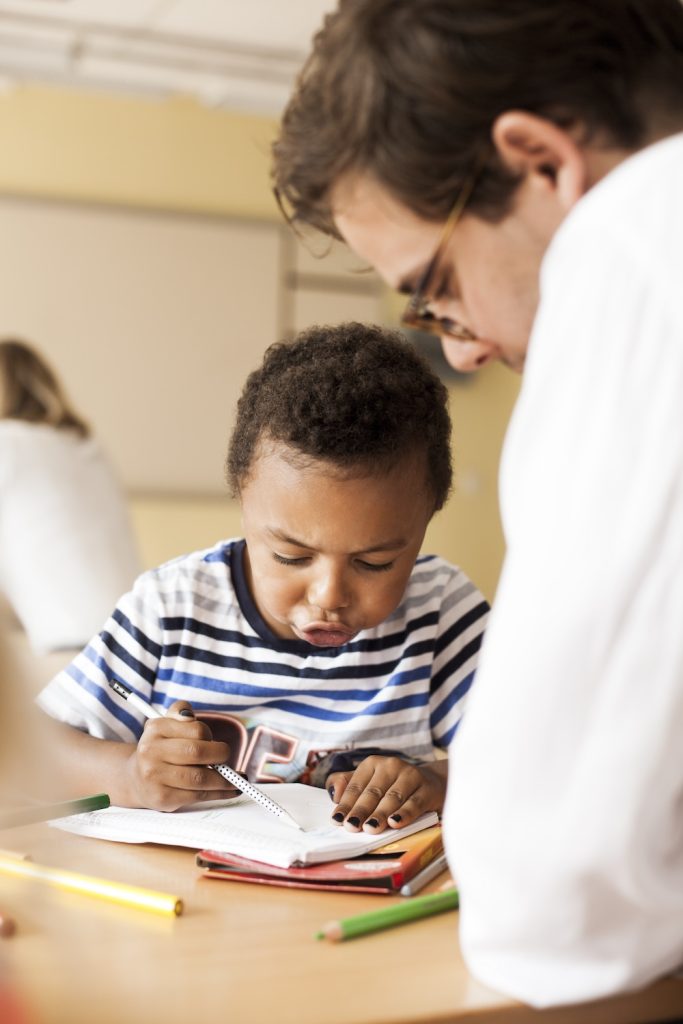 Adult supervising a focused child