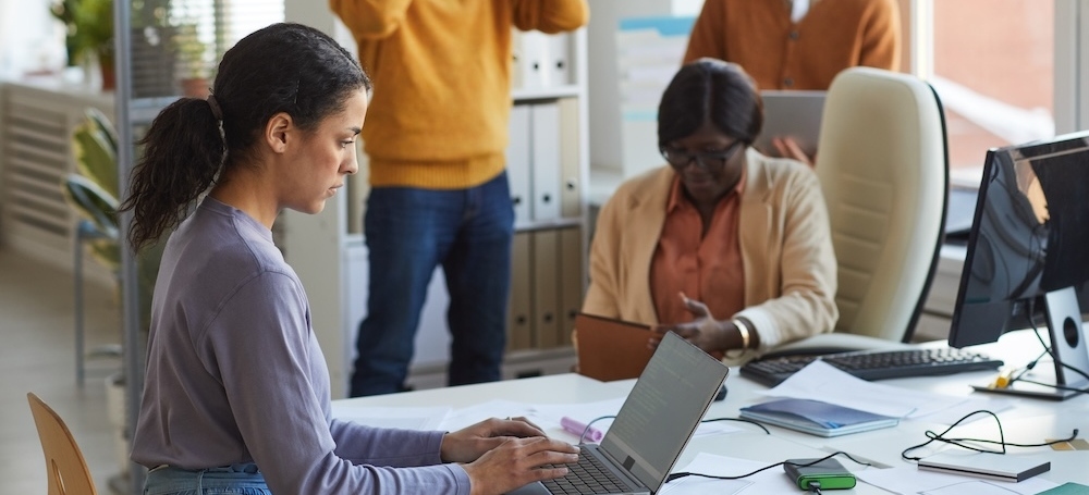 Employee on laptop in the workplace