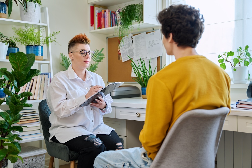 professional therapist working with client