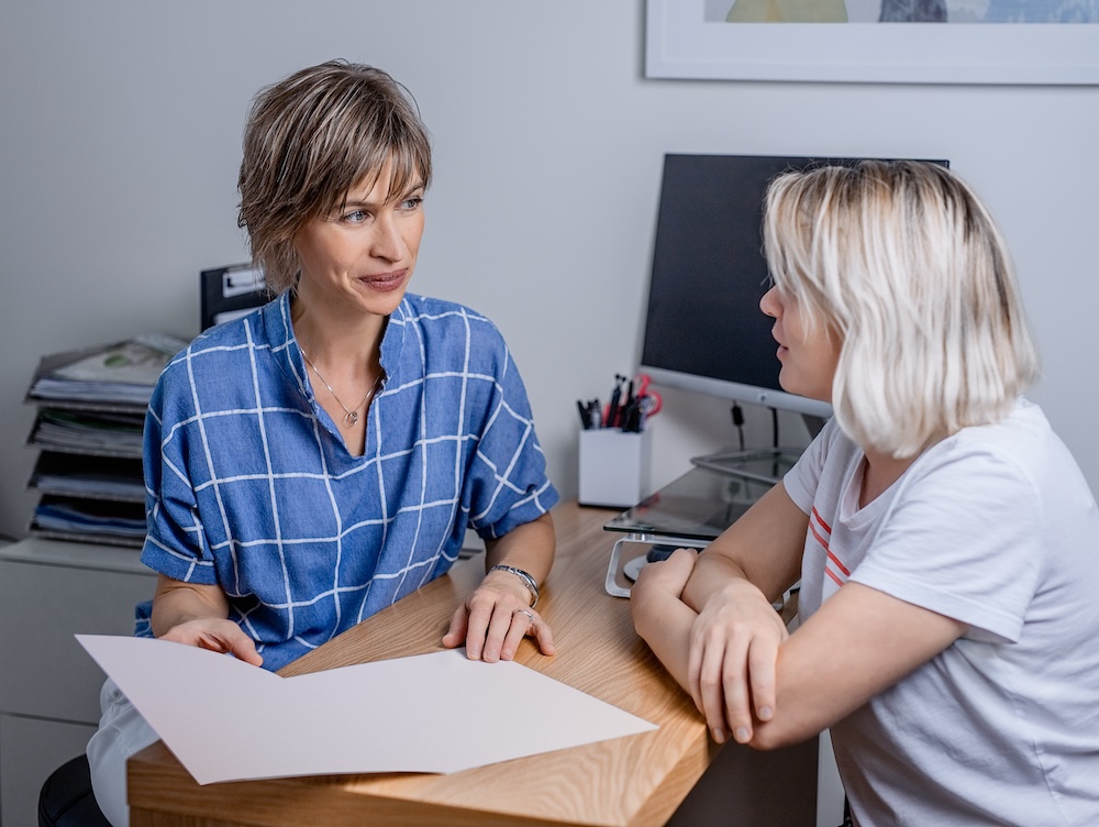 Two women talking in office