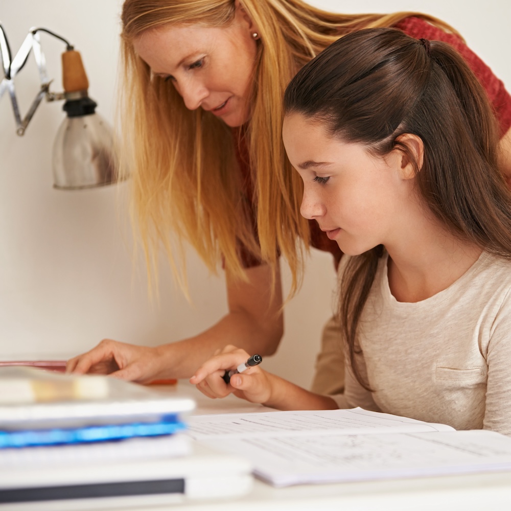 Mother helping her daughter with homework