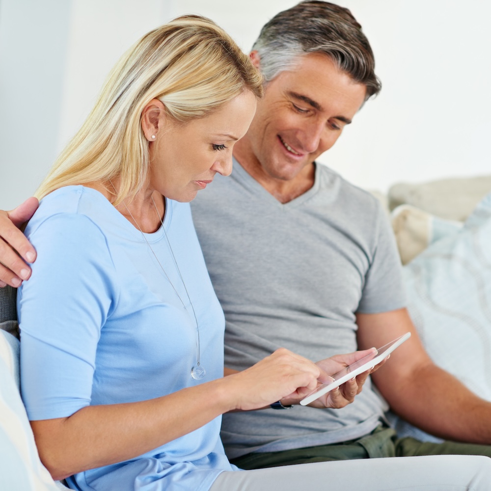 Parents looking at test results on tablet.