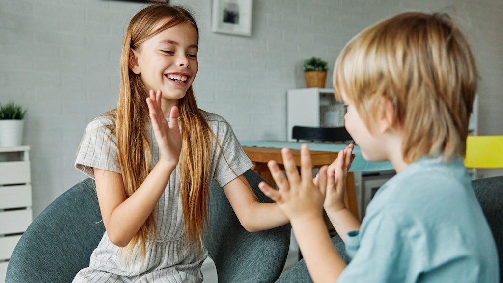 Young children practicing communication skills with one another. 