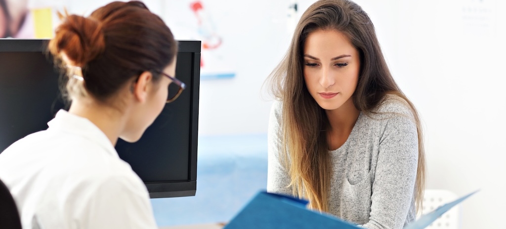 Picture of adult woman having a visit at female doctor's office