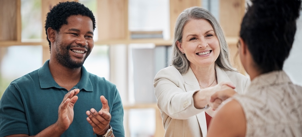 Patient shaking advisors hand regarding insurance coverage