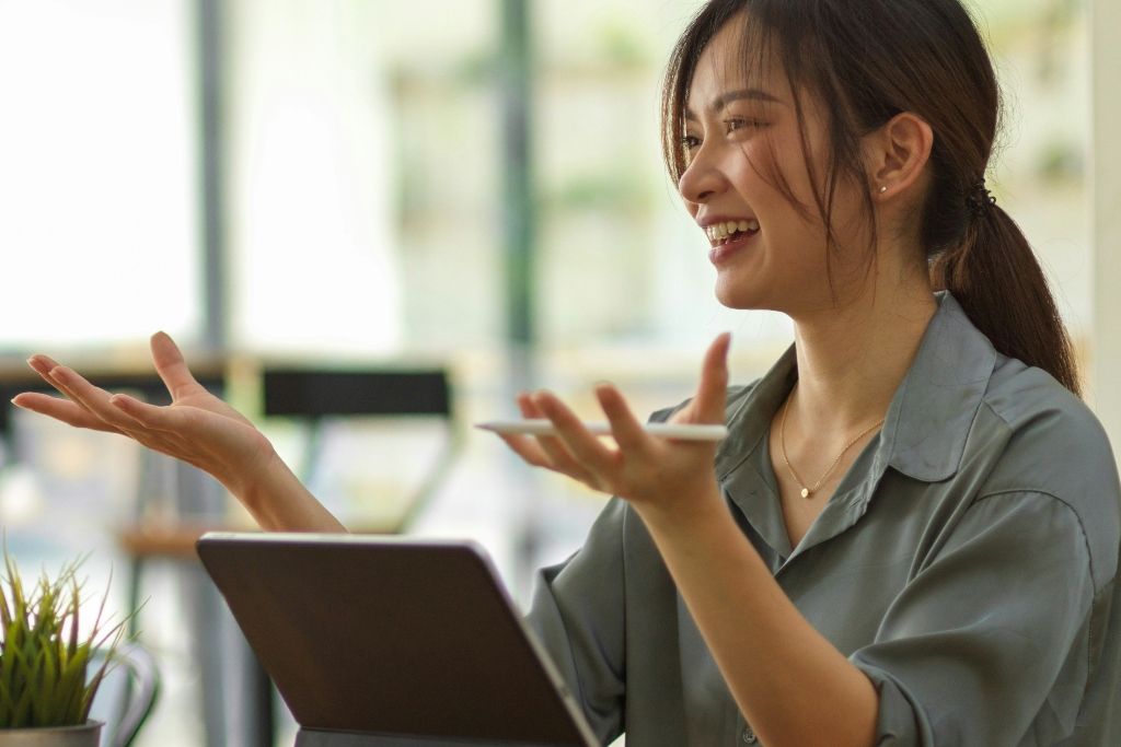 Adult mental health professional, smiling while discussing findings on ipad with treatment professional.