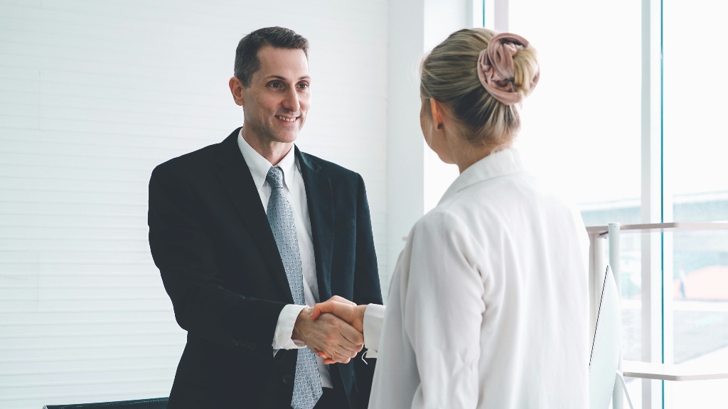 Clinician shaking hand of mental health professional