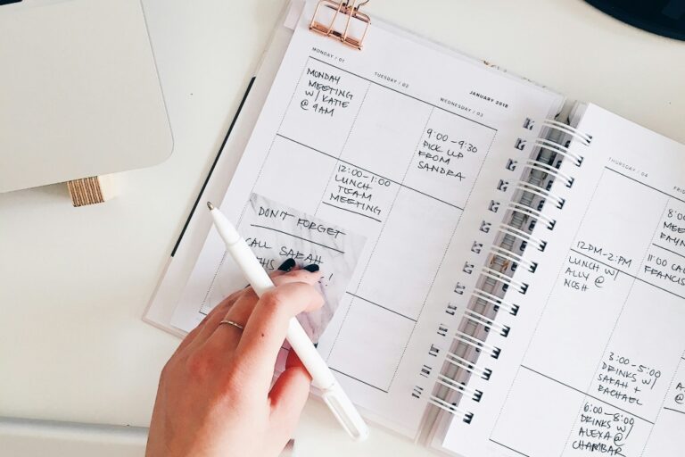 Open weekly planner with handwritten notes and reminders, illustrating planning, organization, and executive functioning.