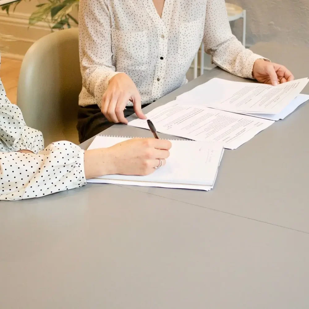 Two people filling out paperwork