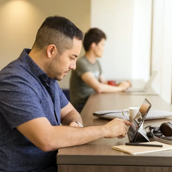 Intelligence Testing Young man working on a tablet computer in a workspace